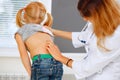 Pediatrician examining little girl