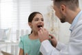 Pediatrician examining girl in office at hospital Royalty Free Stock Photo