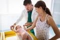 Pediatrician with mother and baby on examination in hospital. Heatlhcare, family, doctor concept. Royalty Free Stock Photo