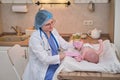 A pediatrician keeps money in euros for paying for the treatment of a newborn baby. A doctor in uniform with money for a visit to