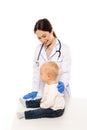 Pediatrician in latex gloves touching toddler