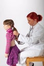 The pediatrician listens on a little girl