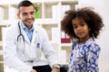 Pediatrician looking to his little girl patient Royalty Free Stock Photo