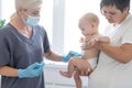 Pediatrician makes vaccination to small boy Royalty Free Stock Photo