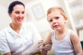 Pediatrician makes vaccination to small boy Royalty Free Stock Photo