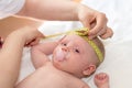 Pediatrician measuring head of baby