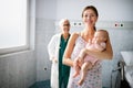 Pediatrician with mother and baby on examination in hospital. Heatlhcare, family, doctor concept. Royalty Free Stock Photo