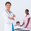 Pediatrician and nurse attending to a child Royalty Free Stock Photo