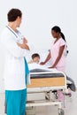 Pediatrician and nurse attending to a child Royalty Free Stock Photo