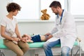 Pediatrician Palpating Stomach of Little Child