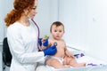 Pediatrician providing healthcare for her baby patient in the office of a specialized clinic for children. Neonatologist