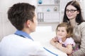 Pediatrician shaking hand with girl child patient