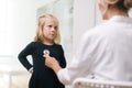 Pediatrician with stethoscope examining young kid girl with blond hair Royalty Free Stock Photo