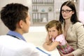 Pediatrician talking to mother and upset child Royalty Free Stock Photo