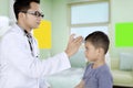 Pediatrician using a digital thermometer for patient Royalty Free Stock Photo