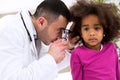 Pediatrician using otoscope