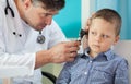 Pediatrician using otoscope