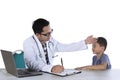 Pediatrician writing a prescription for his patient Royalty Free Stock Photo