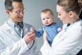 pediatricians checking breath of adorable Royalty Free Stock Photo