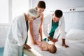 Pediatricians doctors examining little cute baby in hospital Royalty Free Stock Photo