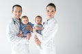 pediatricians holding little babies and looking at camera Royalty Free Stock Photo