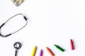 Pediatrics equipment with crayons , stethoscope white background Royalty Free Stock Photo