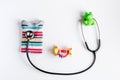 Pediatrics equipment with toys, stethoscope white background top view space for text