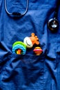 Pediatrics pocket with toys on blue background top view space fo