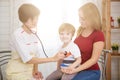 Pediatrist examinate young patient`s lungs with stethoscope Royalty Free Stock Photo