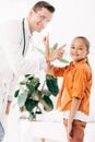 Pediatrist in white coat and child in clinic