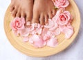 Pedicure, beauty and feet of a woman with flowers for cleaning, treatment and detox. Spa, dermatology and above foot of Royalty Free Stock Photo