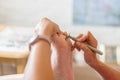 Pedicure dead skin remover foot rasp woman in nail salon. Removing corns on the foot with a razor Royalty Free Stock Photo