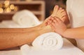 Pedicure, foot therapist and massage at spa for acupressure treatment, wellness therapy and zen. Closeup, client and Royalty Free Stock Photo