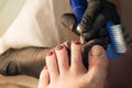 Pedicure removing old coating. Chiropody