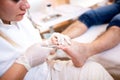 Pedicure salon lady trimming nails of a young manÃ¢â¬â¢s foot