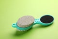 Pedicure tool with pumice stone, brush and foot file on green background Royalty Free Stock Photo