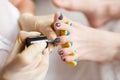 Pedicurist applying nail polish, close up photo