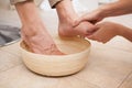 Pedicurist cleansing customer feet