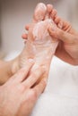 Pedicurist covering customers foot in soap Royalty Free Stock Photo