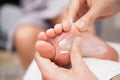 Pedicurist massaging a customers foot