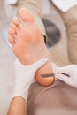 Pedicurist removing dead skin