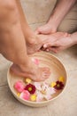 Pedicurist washing a customers feet Royalty Free Stock Photo