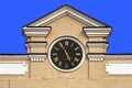 Pediment with a clock of an old Moscow building isolated on a blue background