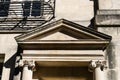 The pediment of a doorway on Brock Street, Bath with engaged Ionic columns