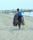 Pedlar of cloth and towels on the beach in summer