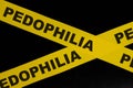 Pedophilia caution and warning concept. Yellow barricade tape with word in dark black background.