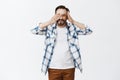 Peek-a-boo cutie. Portrait of friendly and kind handsome mature male with beard, taking off palm from eye and peeking at Royalty Free Stock Photo