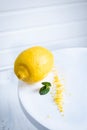 Peel the lemon with a cheese grater. Lemon zest on white background Royalty Free Stock Photo