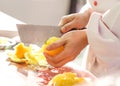 Peel lemon, chef cutting lemon, slicing lemon on the cutting board with knife in kitchen Royalty Free Stock Photo