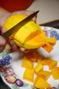 Peel the mango on a plate in the kitchen Royalty Free Stock Photo